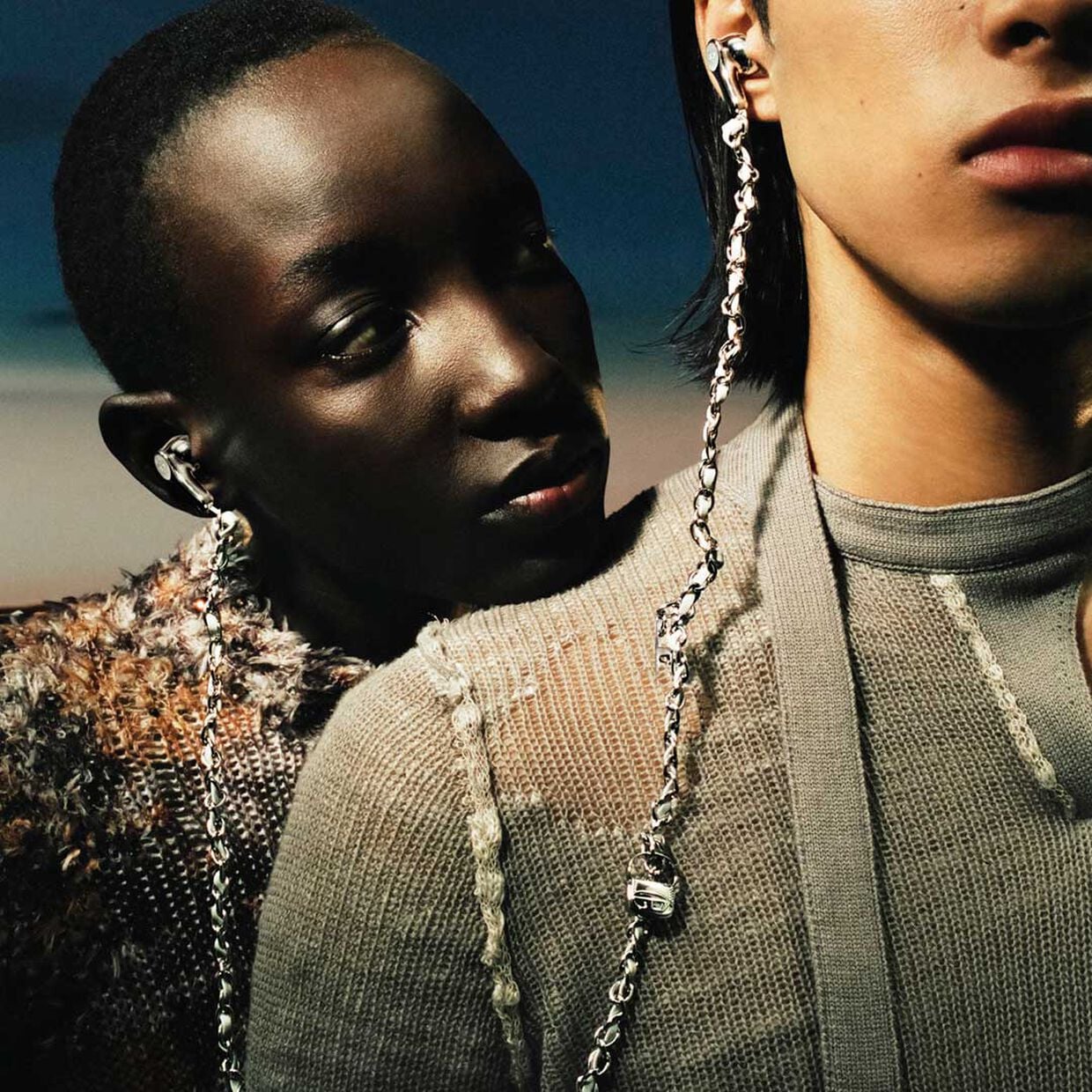 Model wearing the wired headphones in silver with charms, only at Diesel.